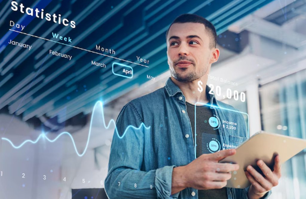 A confident man holding a tablet in a modern office environment, surrounded by digital financial statistics and graphs, symbolizing data analytics and the role of investment fintechs in personal finance management.